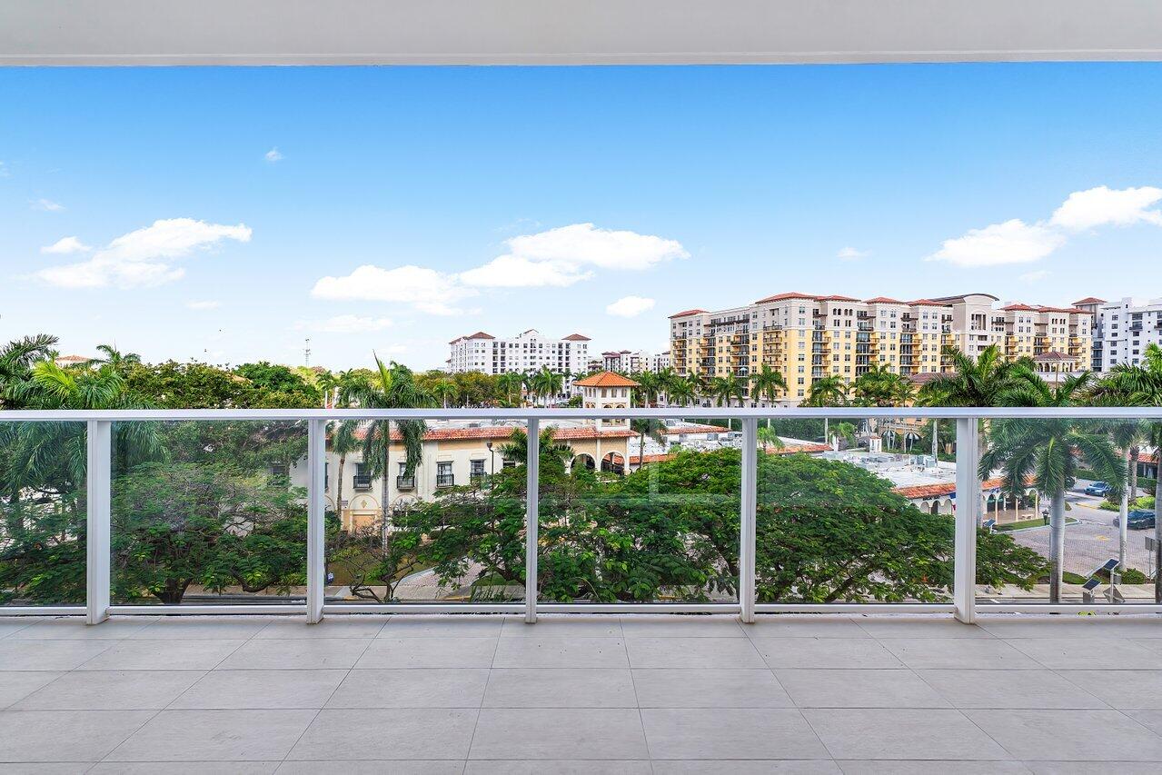 220 Southeast Mizner Boulevard, Unit 506 Boca Raton, FL 33432 - Photo 36 of 64 a view of a balcony next to a yard