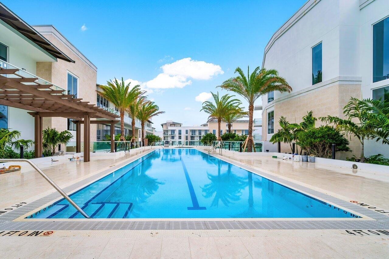 220 Southeast Mizner Boulevard, Unit 506 Boca Raton, FL 33432 - Photo 49 of 64 a swimming pool with outdoor seating and yard