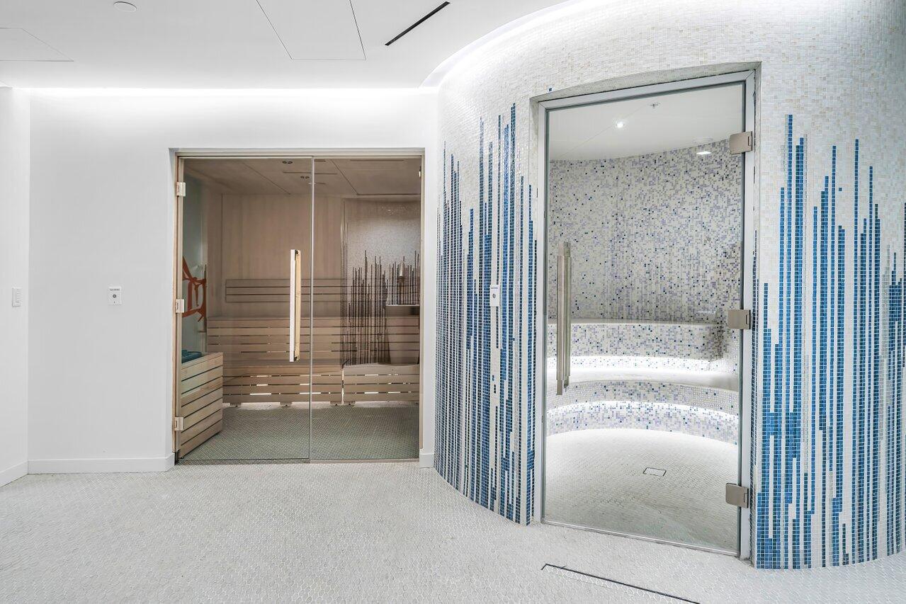 220 Southeast Mizner Boulevard, Unit 506 Boca Raton, FL 33432 - Photo 55 of 64 wooden view of a bathroom with a glass door shower and a sink