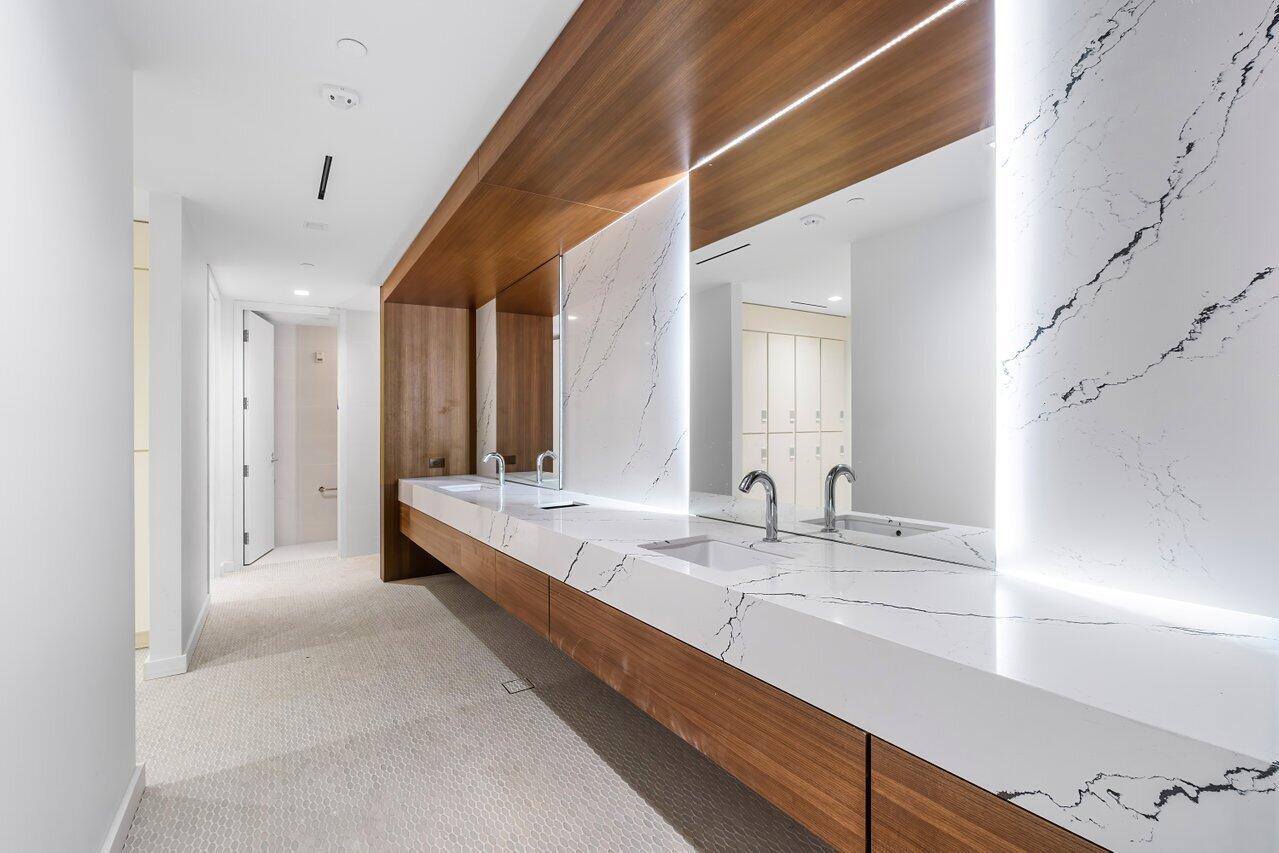 220 Southeast Mizner Boulevard, Unit 506 Boca Raton, FL 33432 - Photo 56 of 64 a large white room with a large mirror and sink