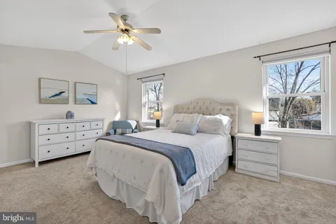 a spacious bedroom with a bed and a chandelier