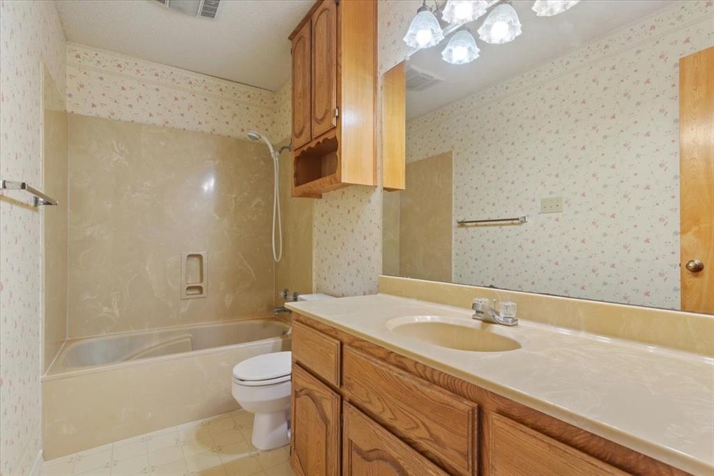 146 Indian Paint Brush Road Eddy, TX 76524 - Photo 20 of 38 a bathroom with a sink a toilet and shower