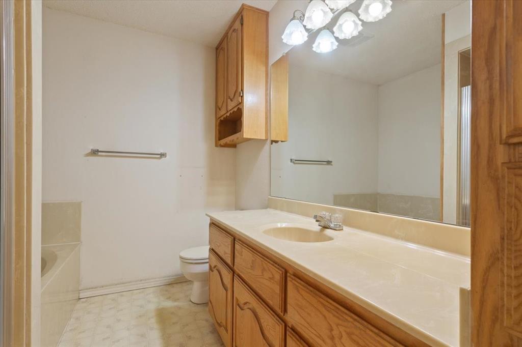146 Indian Paint Brush Road Eddy, TX 76524 - Photo 22 of 38 a bathroom with a sink a toilet and a mirror