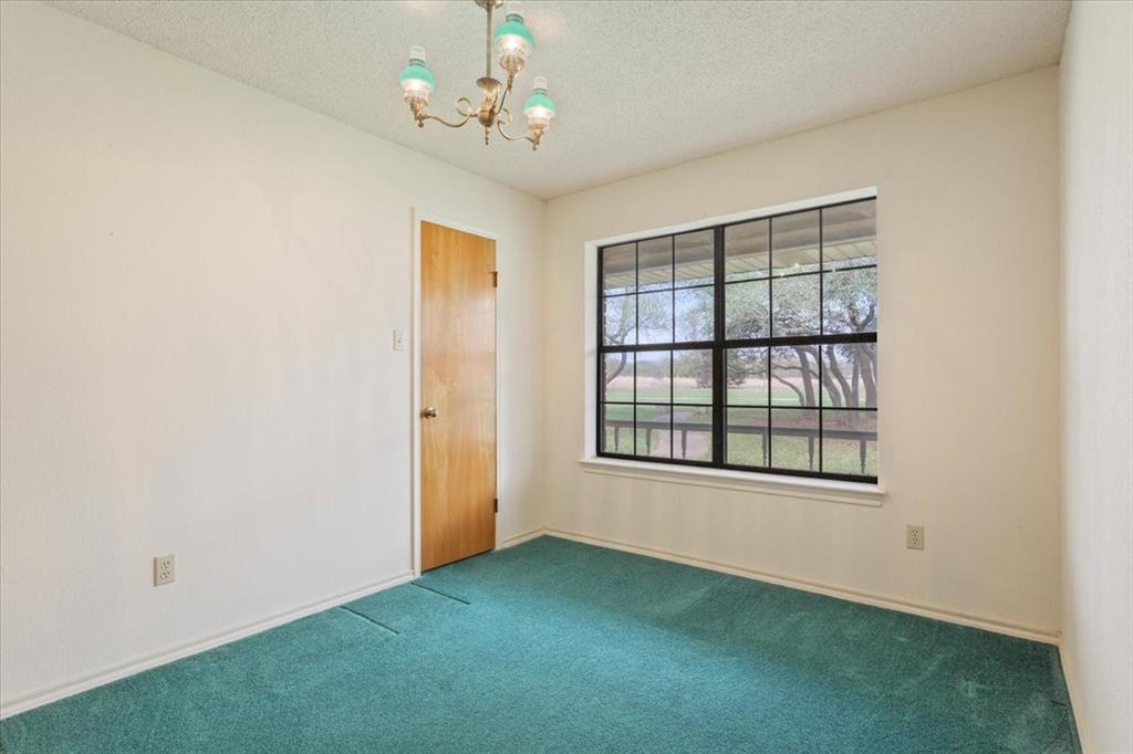 146 Indian Paint Brush Road Eddy, TX 76524 - Photo 24 of 38 an empty room with chandelier fan and windows