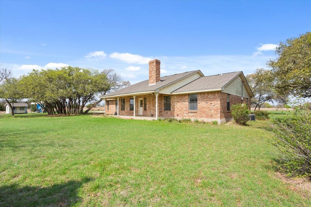 146 Indian Paint Brush Road Eddy, TX 76524 - Photo 29 of 38 a front of a house with a garden