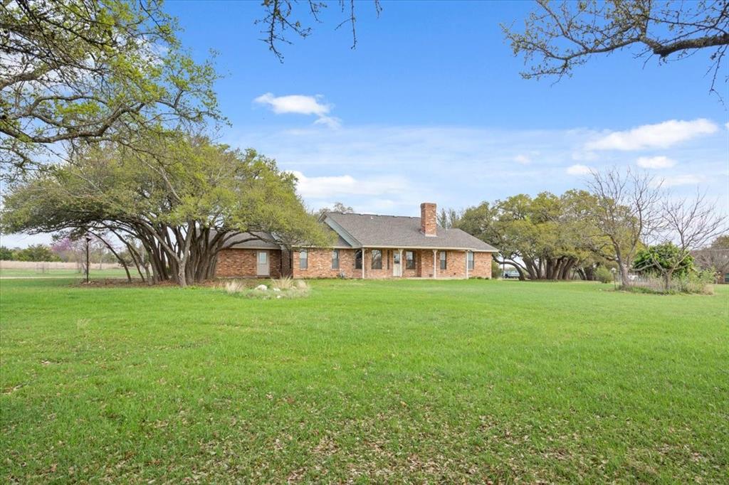 146 Indian Paint Brush Road Eddy, TX 76524 - Photo 3 of 38 a view of a big yard with a house