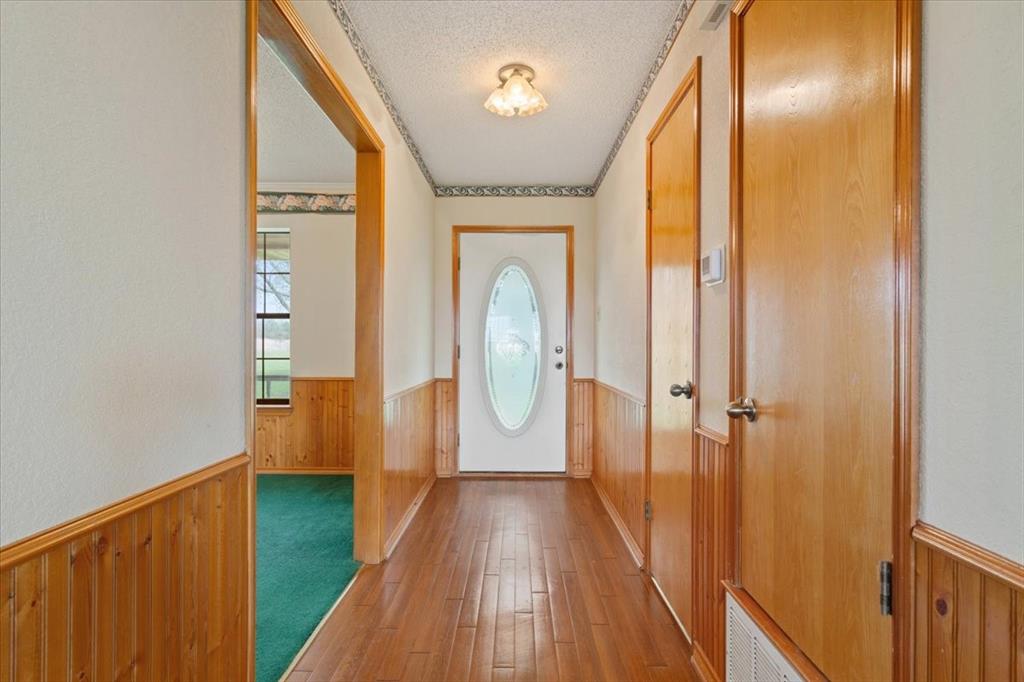 146 Indian Paint Brush Road Eddy, TX 76524 - Photo 5 of 38 a view of a hallway with wooden floor and staircase