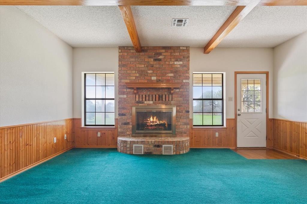 146 Indian Paint Brush Road Eddy, TX 76524 - Photo 8 of 38 an empty room with windows and fireplace