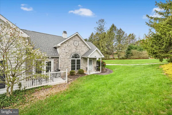 a view of a house with a yard and sitting area
