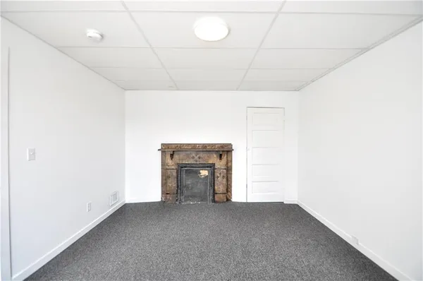 a view of empty room with a fireplace