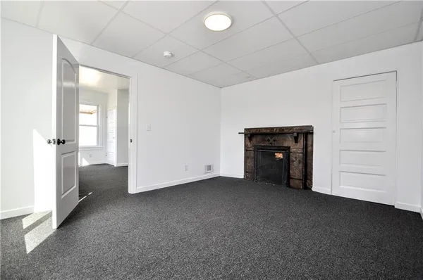 an empty room with closet and mirrors