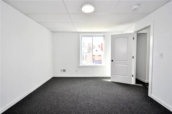 an empty room with windows and closet