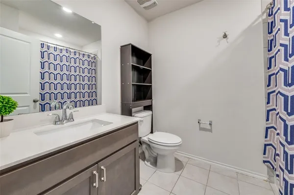 a bathroom with a shower and a sink