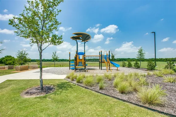 a view of a patio with a table and chairs under an umbrella