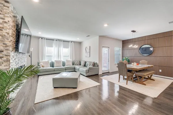 a view of a workspace with furniture and wooden floor