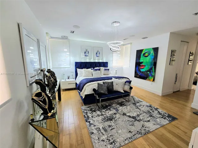 a bedroom with furniture and a wooden floor