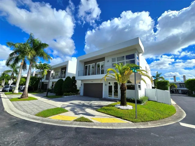 a view of a house with swimming pool and trees in the background