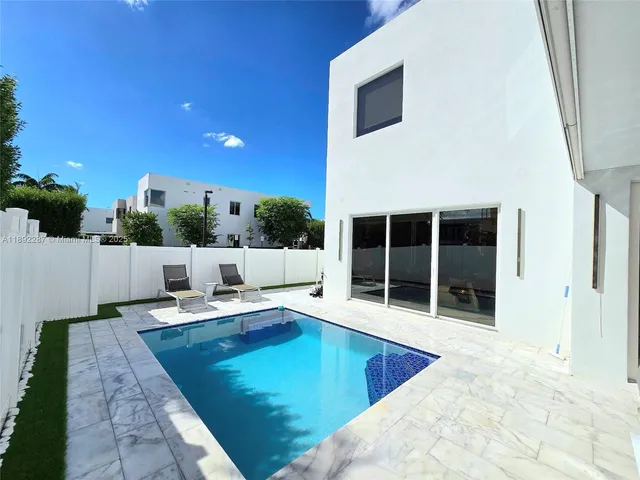 an aerial view of multiple houses with outdoor space