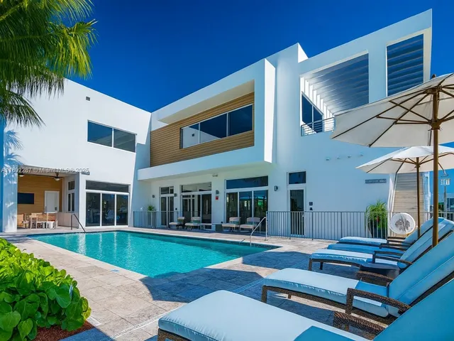 a room with gym equipment and large windows