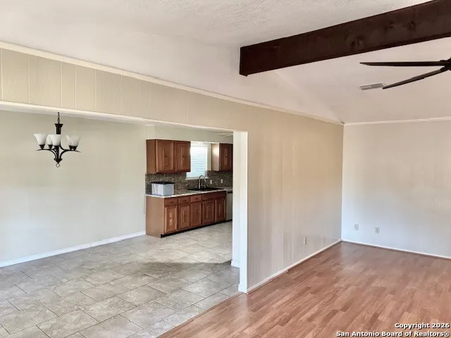 a living room with hard wood floors and a ceiling fan