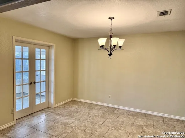 a view of a chandelier fan and a window