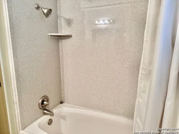 a bathroom with a white bath tub