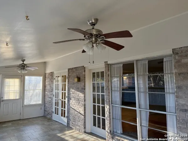 a view of a livingroom with a ceiling fan and window