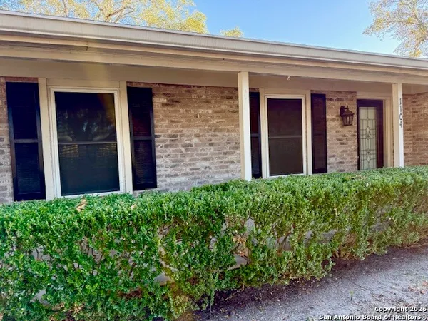 a view of a house with potted plants