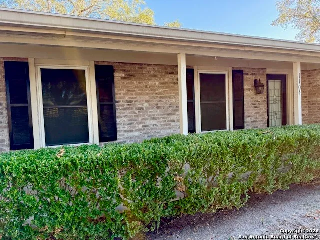 a view of a house with potted plants