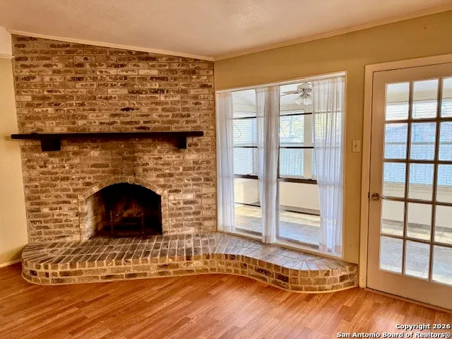 a living room with a fireplace and a floor to ceiling window