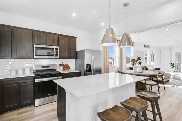 a large kitchen with sink cabinets and stainless steel appliances