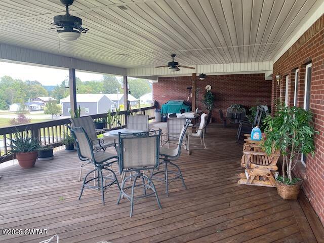 3643 Mt Carmel Road Decaturville, TN 38329 - Photo 38 of 71 a view of a patio with table and chairs potted plants with wooden floor