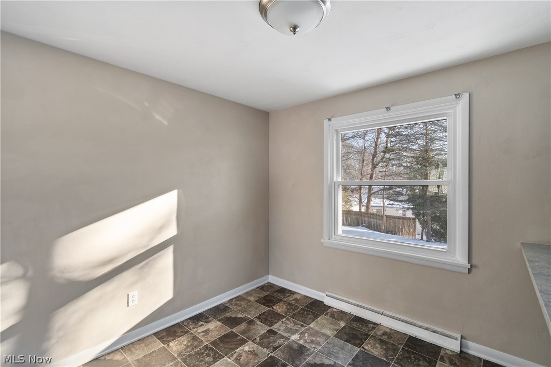 136 South Metzger Avenue Rittman, OH 44270 - Photo 27 of 33 Empty room with baseboard heating and stone finish flooring