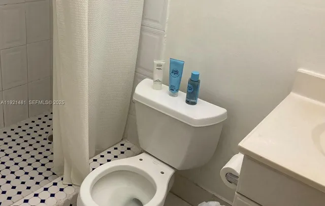 a white toilet sitting next to a bathroom sink