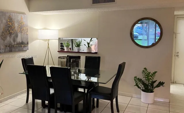 a view of a dining room with furniture and chandelier