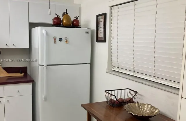 a white refrigerator freezer sitting inside of a kitchen