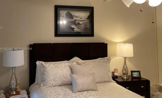 a bedroom with a bed and a lamp