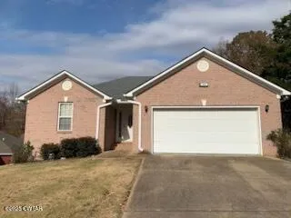 a front view of house with garage and yard