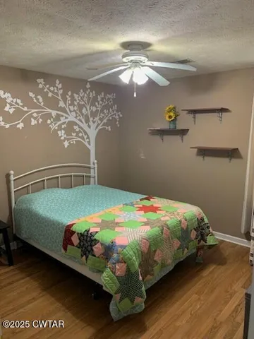 a bedroom with a bed and chandelier