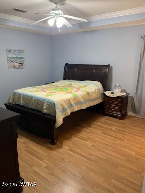 314 Cheyenne Circle Lexington, TN 38351 - Photo 14 of 26 a bedroom with a bed and dresser with wooden floor