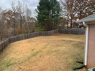 a view of a house with backyard and porch