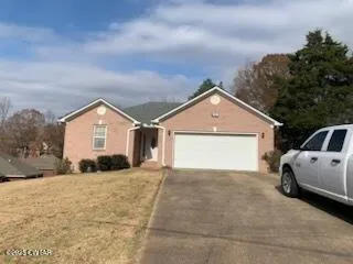 a view of a house with a yard and garage