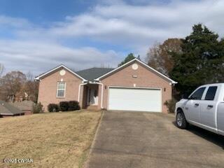 314 Cheyenne Circle Lexington, TN 38351 - Photo 26 of 26 a view of a house with a yard and garage