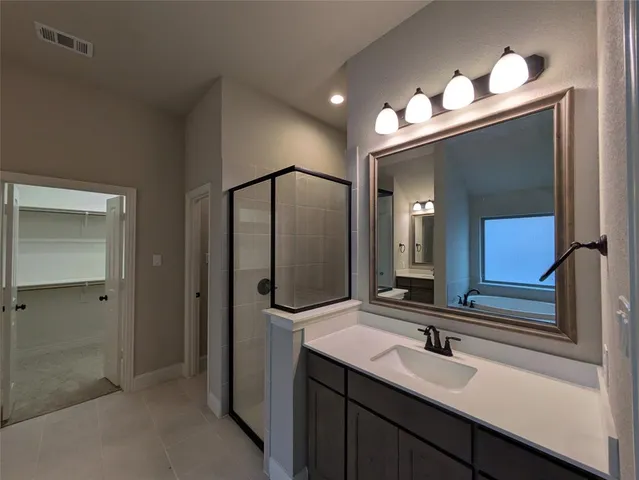 a bathroom with double vanity sink and mirror