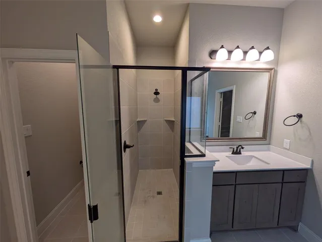a bathroom with a sink vanity and a mirror