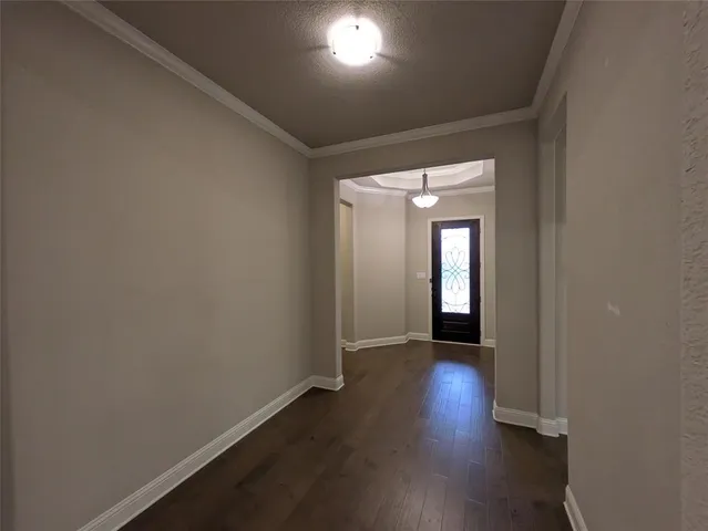 an empty room with wooden floor and a window