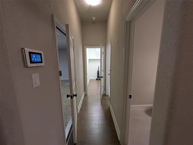 a view of a hallway with wooden floor