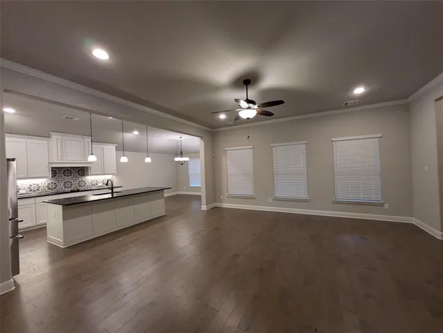 a large kitchen with stainless steel appliances a large counter top