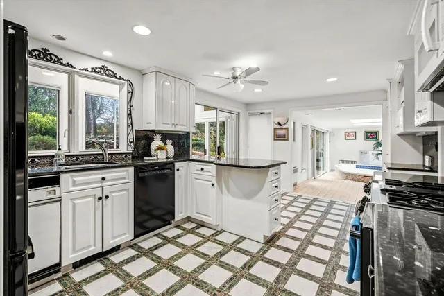 a kitchen with granite countertop a stove sink and refrigerator