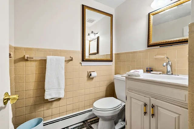 a bathroom with a sink toilet and mirror